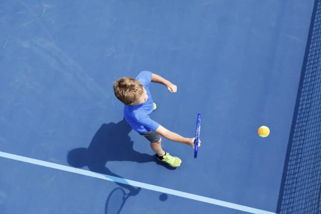 boy playing tennis