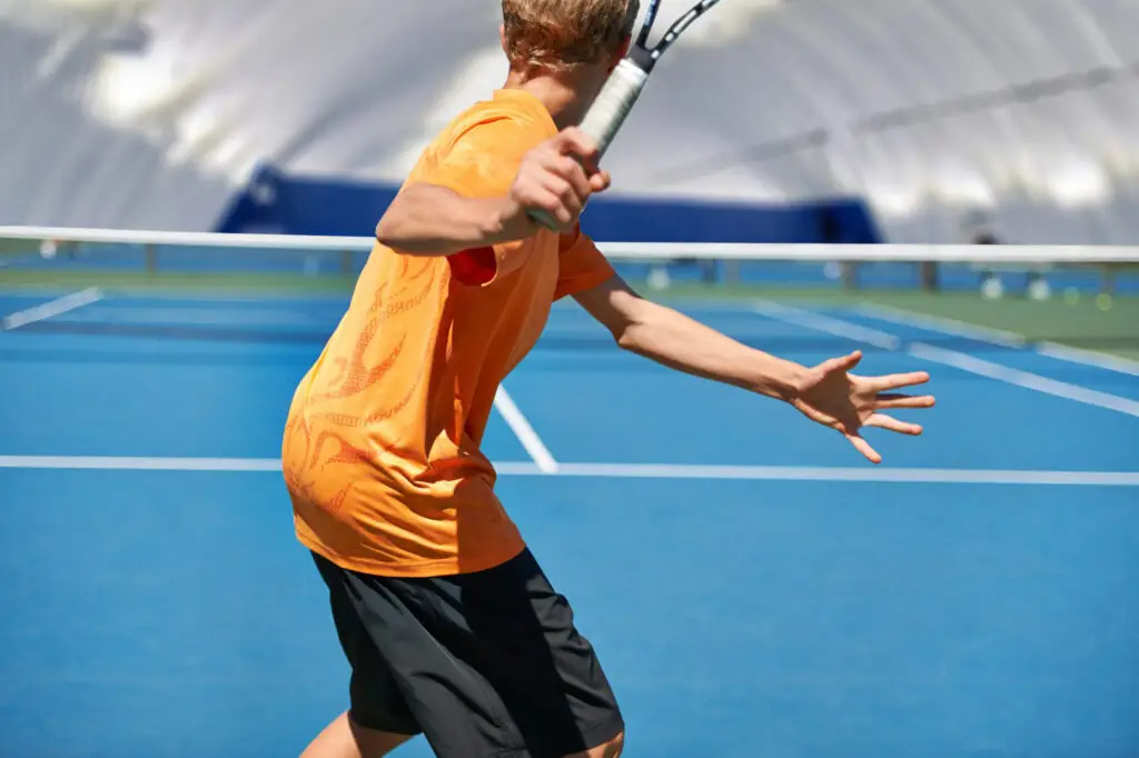 teen playing tennis