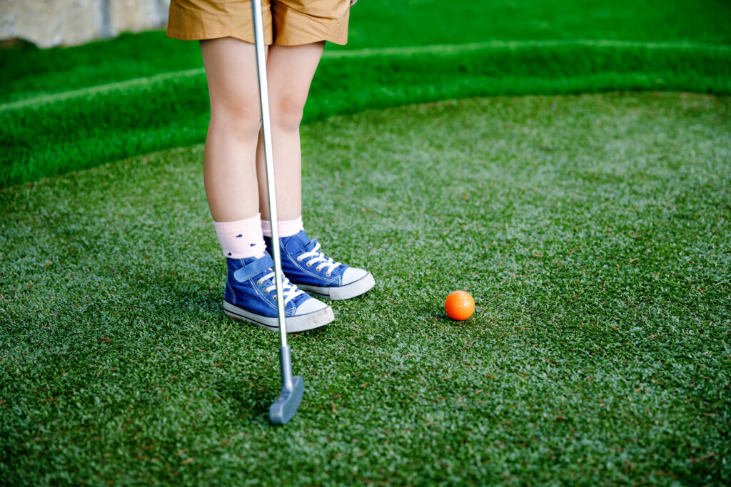 little kid playing golf at tcr